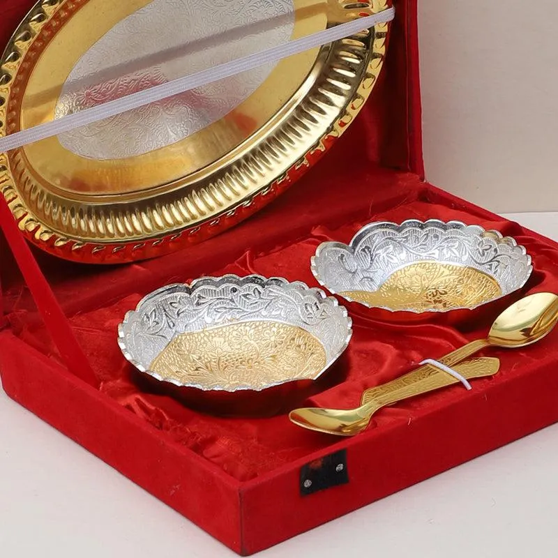 Gold and silver floral dessert bowls, spoons and tray displayed in an open red case