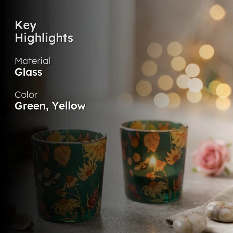 Two green floral candle votives displayed in a softly lit decorative setting.