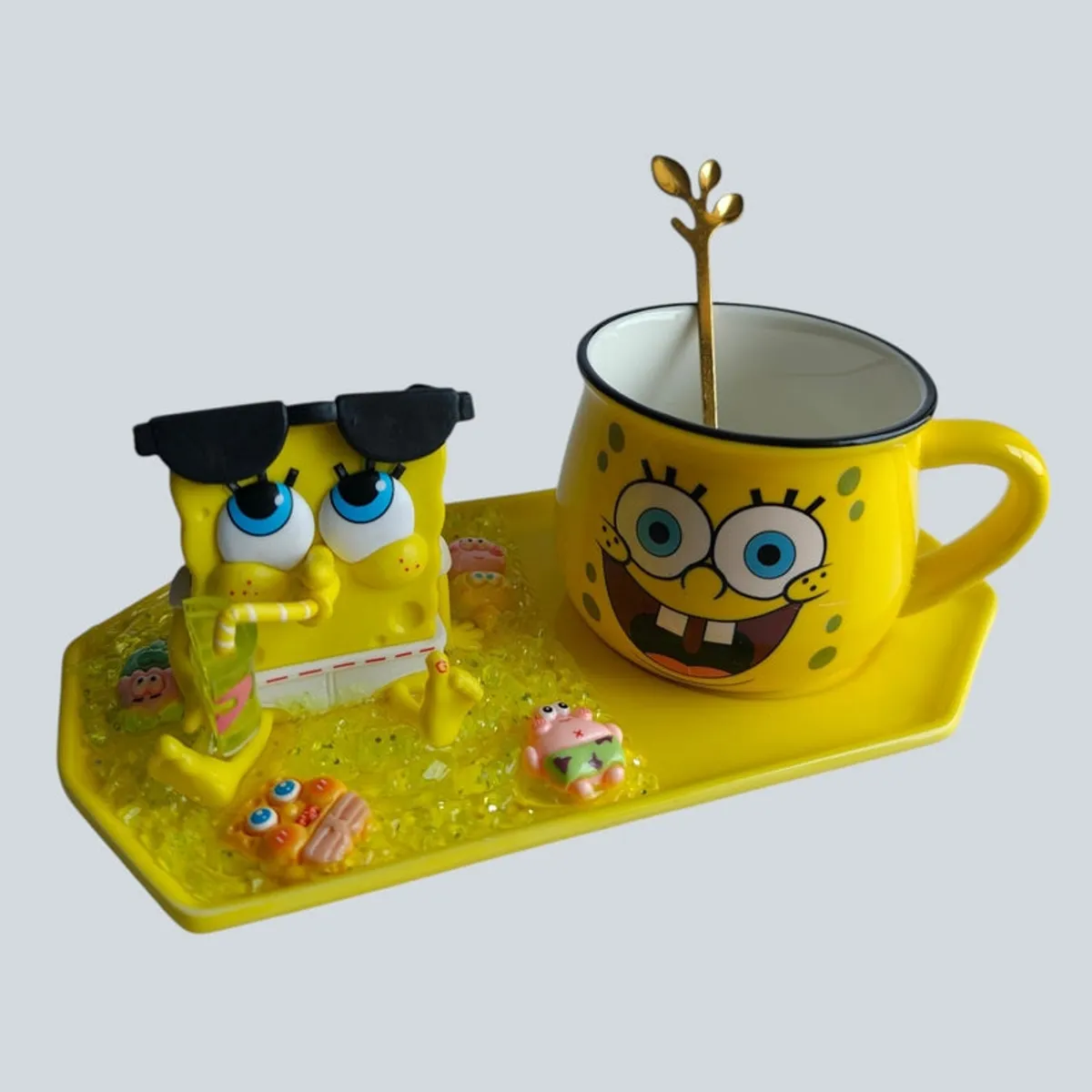 Close view of SpongeBob mug, figurine and spoon on yellow tray