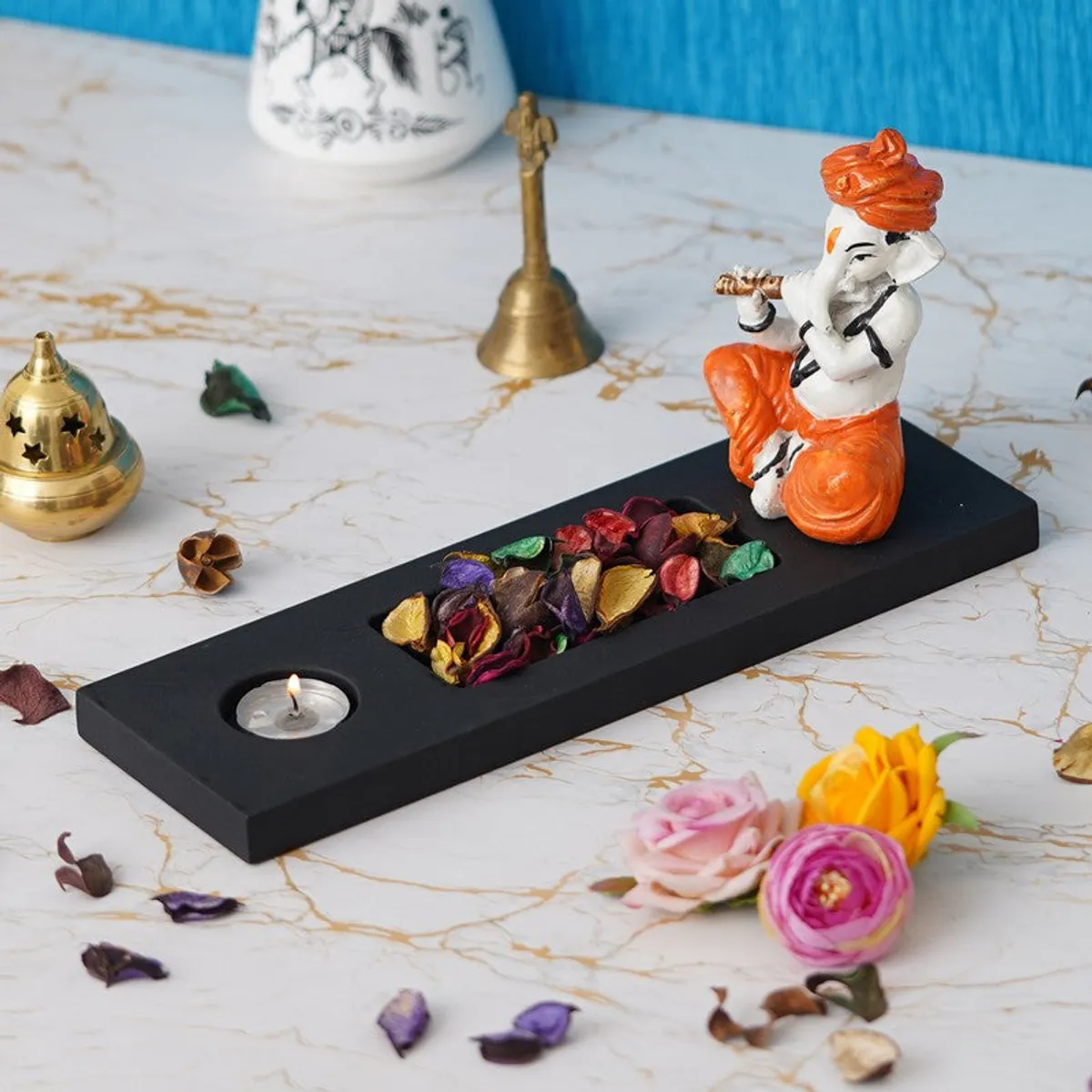 Decorative Ganesha tea light holder with rectangular black base and candle slot