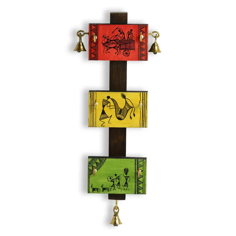 Close front view of the red, yellow and green illustrated panels on a wooden key hook.