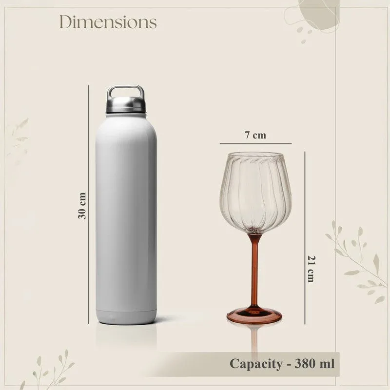 Wine glass shown beside a bottle to illustrate its height and capacity