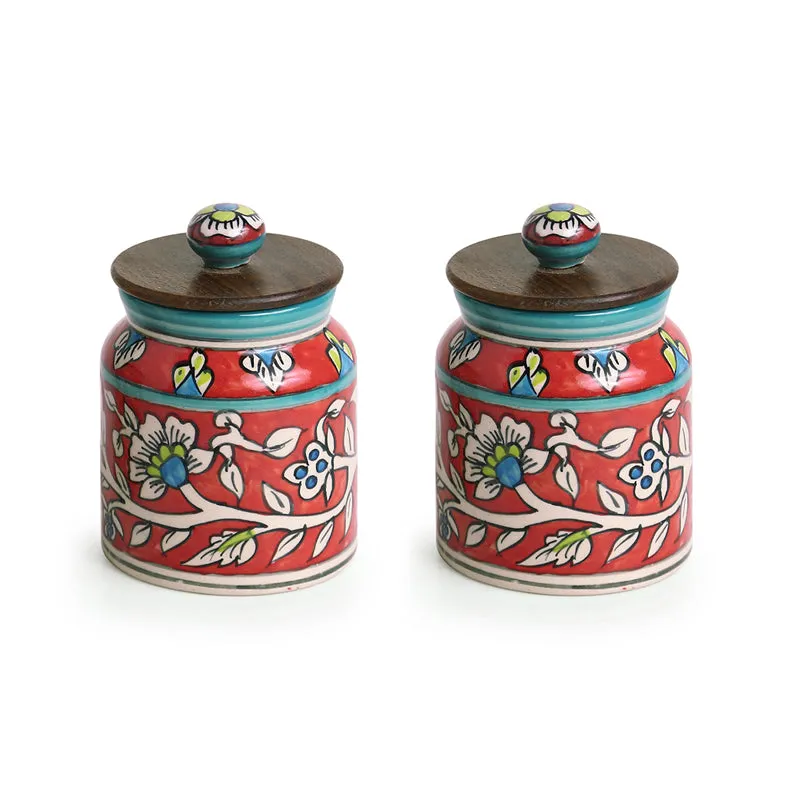Pair of red floral ceramic jars with turquoise accents and wooden lids.