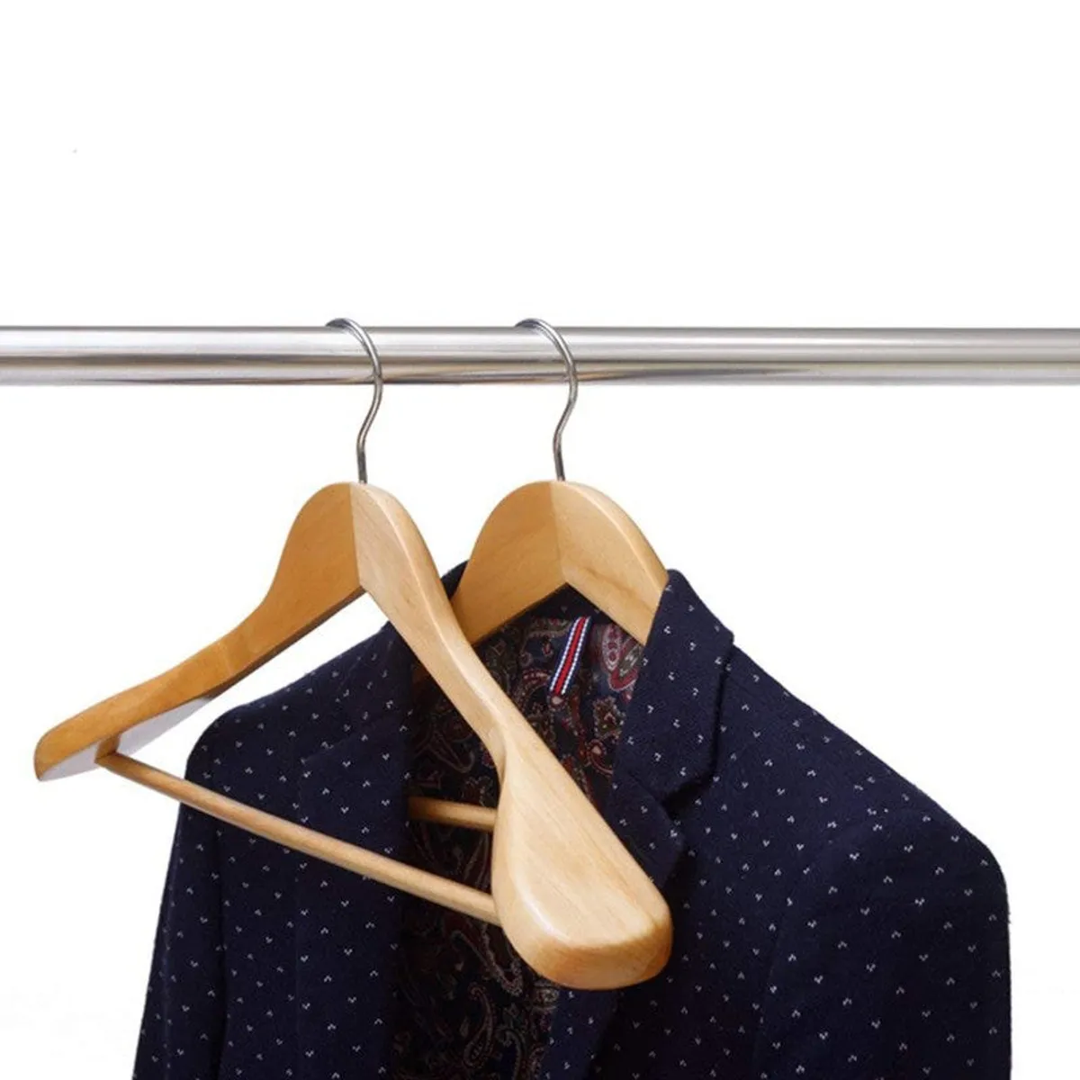 Two wooden hangers holding a navy shirt on a metal rail
