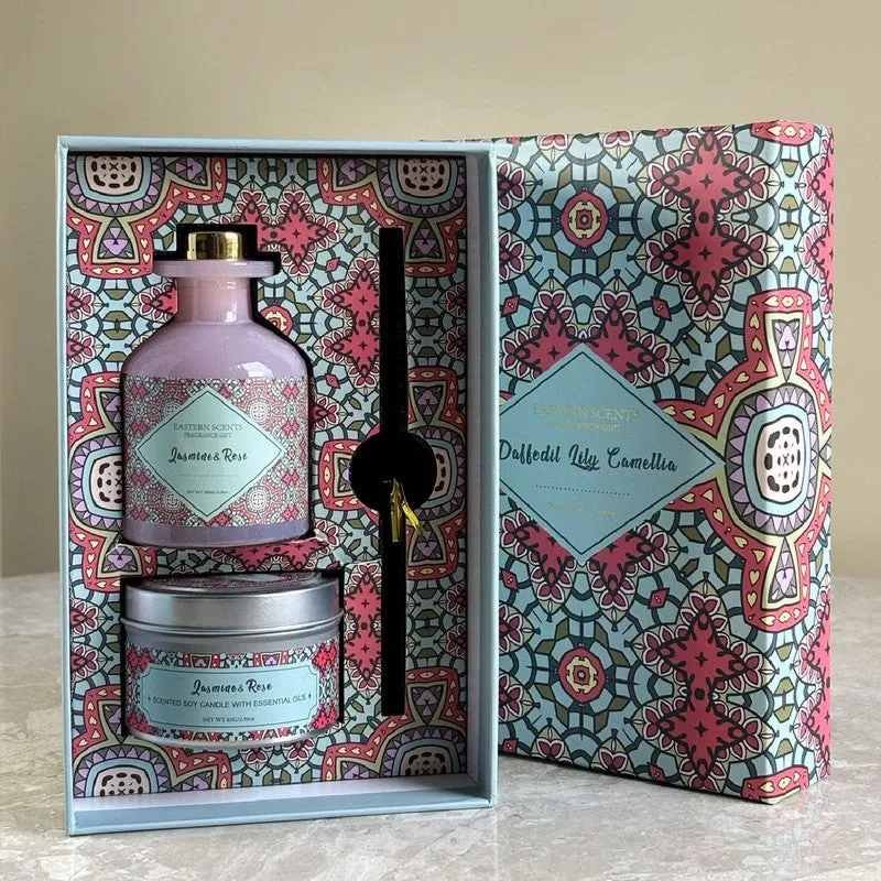 Open fragrance set with pink diffuser, candle and black reeds in a patterned box