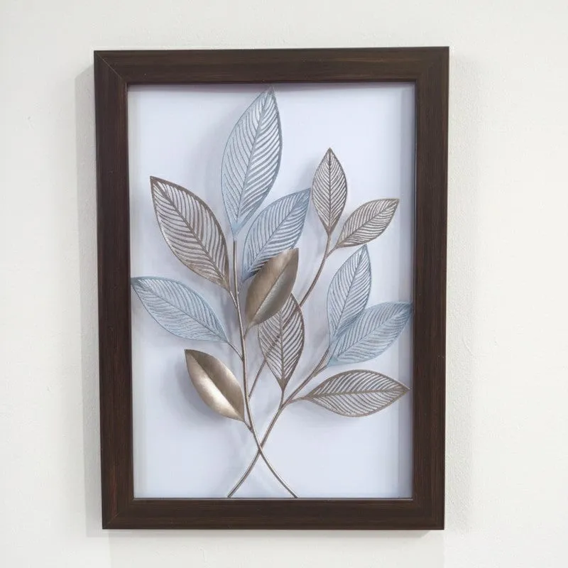 Framed leaf artwork with soft blue and metallic foliage on a white background