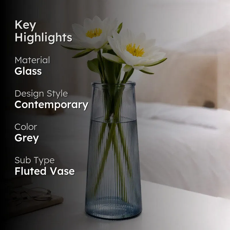 Grey fluted vase with white flowers against a dark overlay