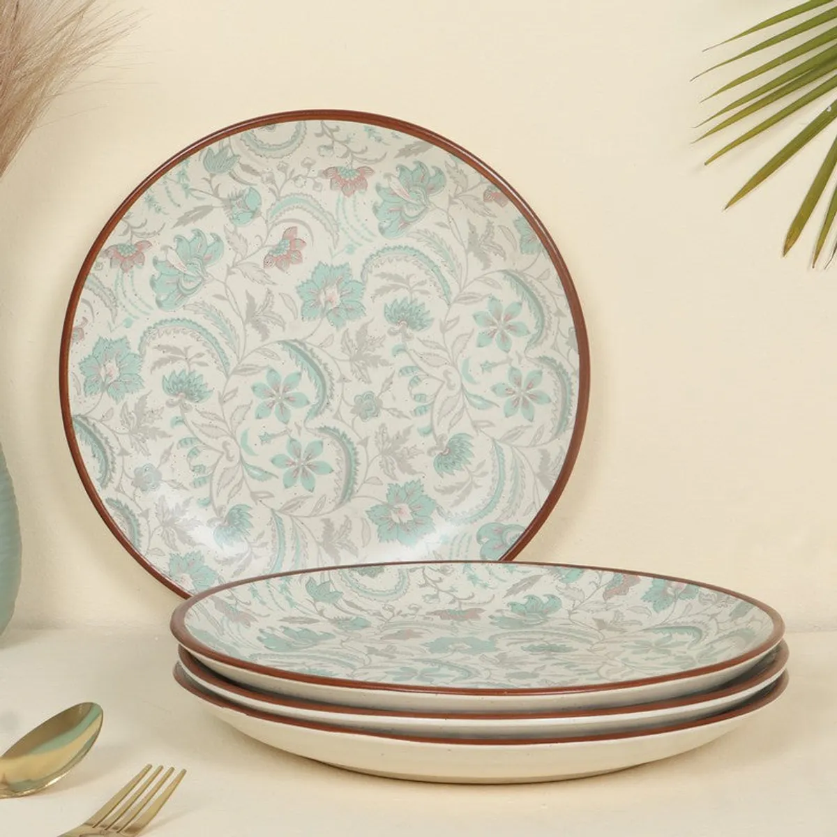 Round patterned plates stacked and displayed against a light background.