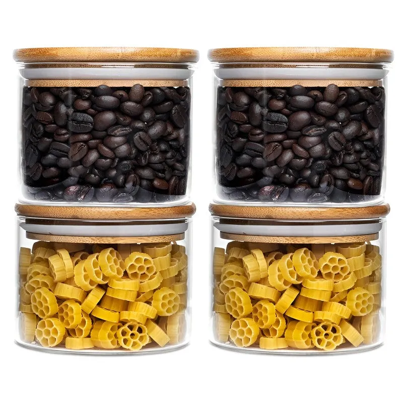Four transparent glass jars with bamboo lids, arranged in two stacks against a white background.
