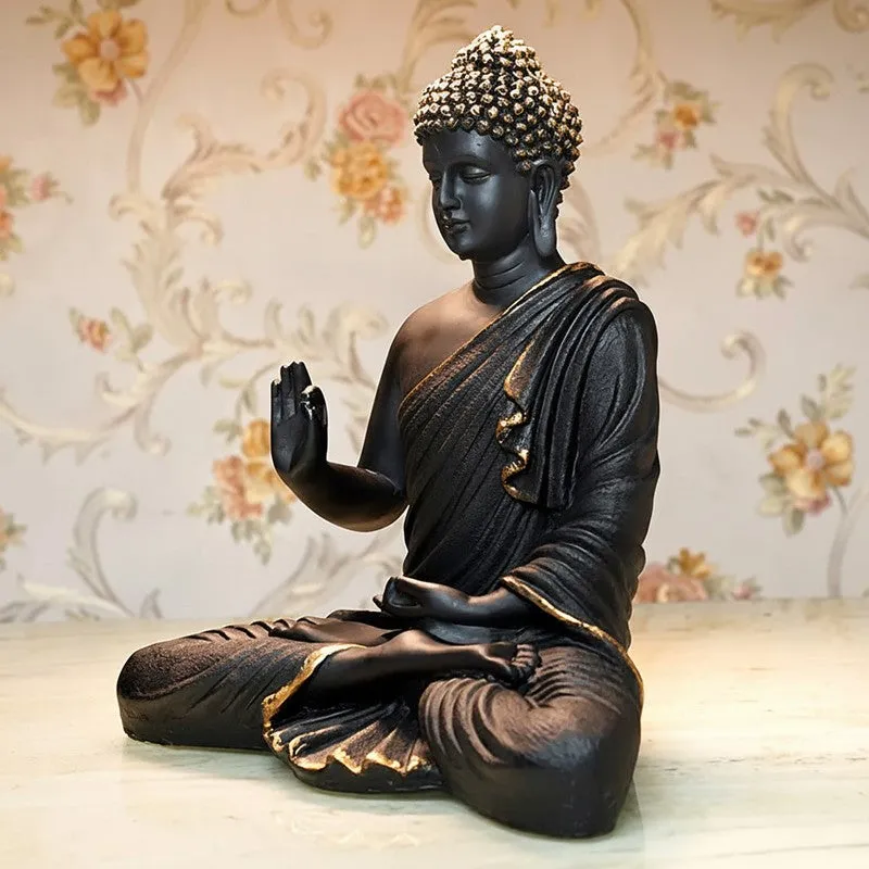 Angled view of a black Buddha idol with gold detailing