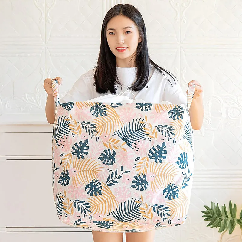Person holding a large pink leafy-print laundry basket by its handles