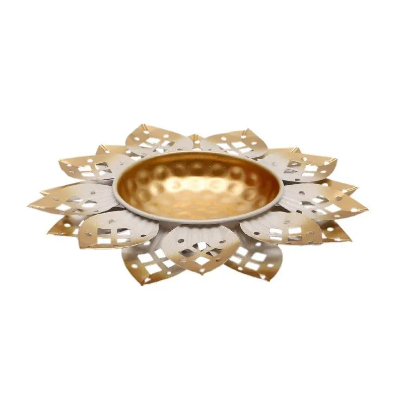 Side view of white and gold iron urli with petal design
