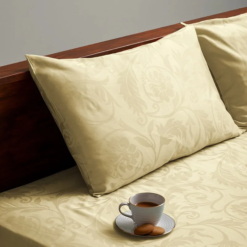 Ivory floral jacquard pillow and duvet cover styled on a wooden bed