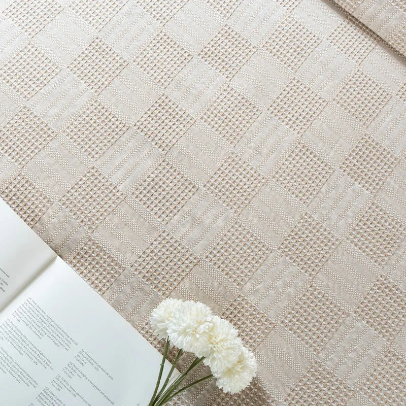 Top view of beige bedsheet showing textured geometric pattern