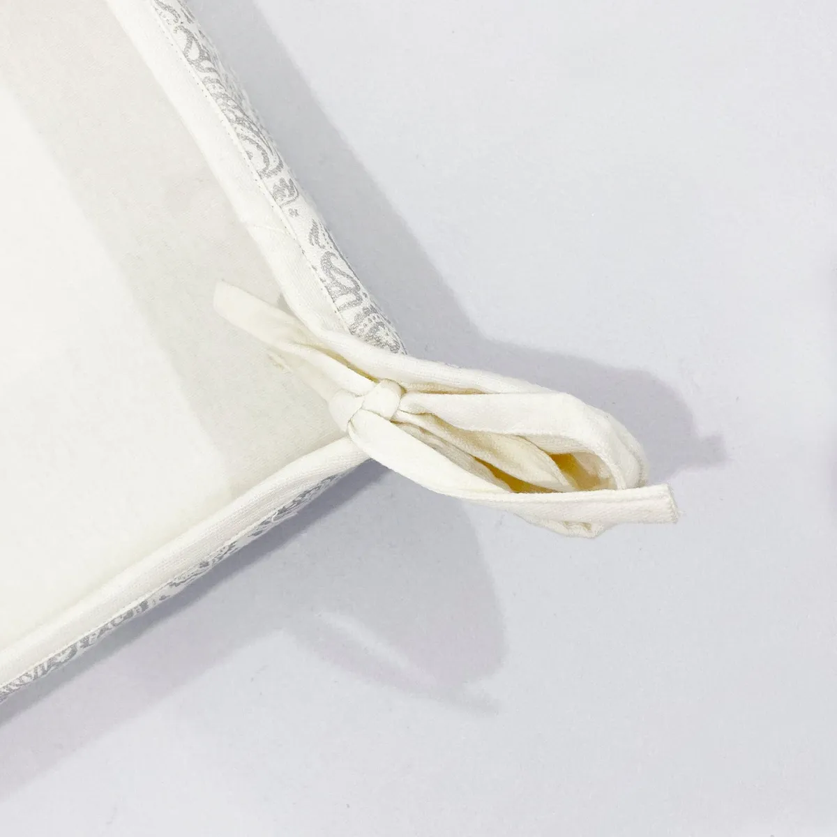 Close-up of the bread basket corner with tied fabric bow