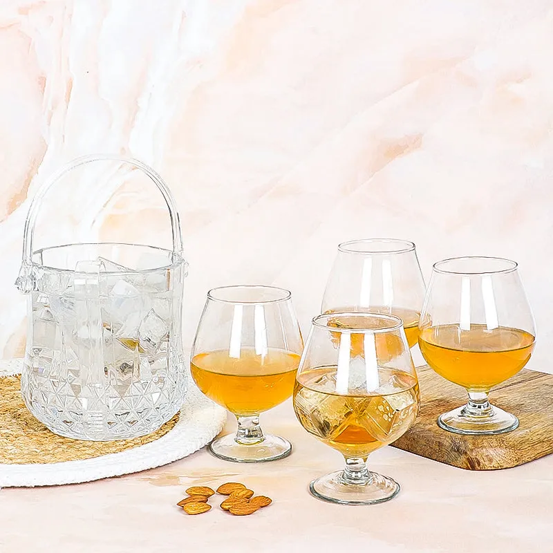 Transparent ice bucket and four glossy snifter glasses on display