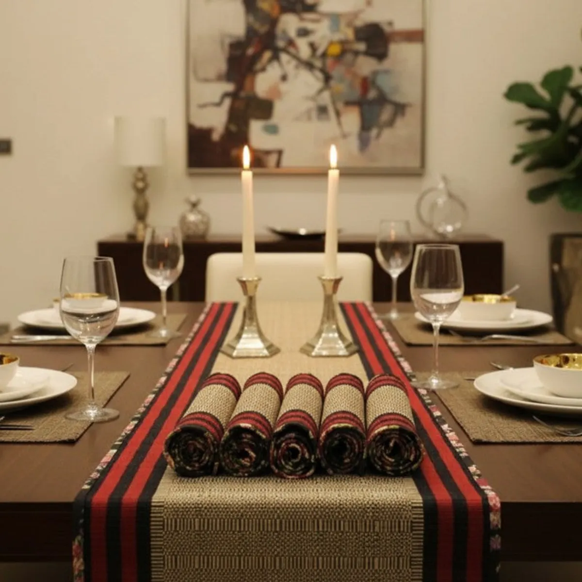 Table runner styled for a formal dinner with plates, glasses and candles