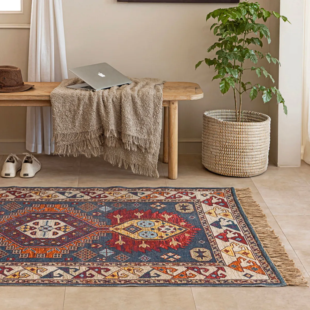 Close view of the rug's geometric pattern and fringed edge