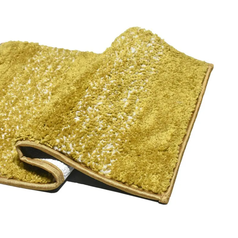 Close-up of the yellow textured bath mat with bound edges
