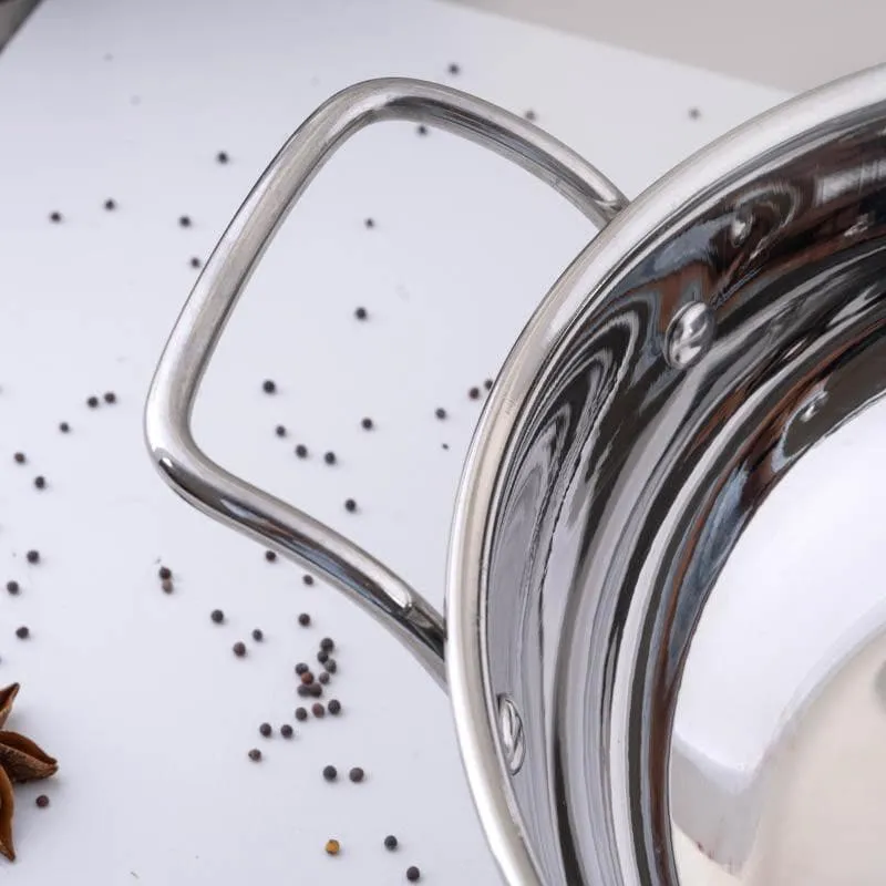 Close-up of the stainless steel kadhai's ergonomic side handle and rim