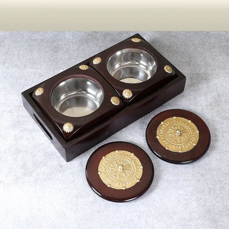 Open two-compartment brown dry fruit container with its lids placed beside it
