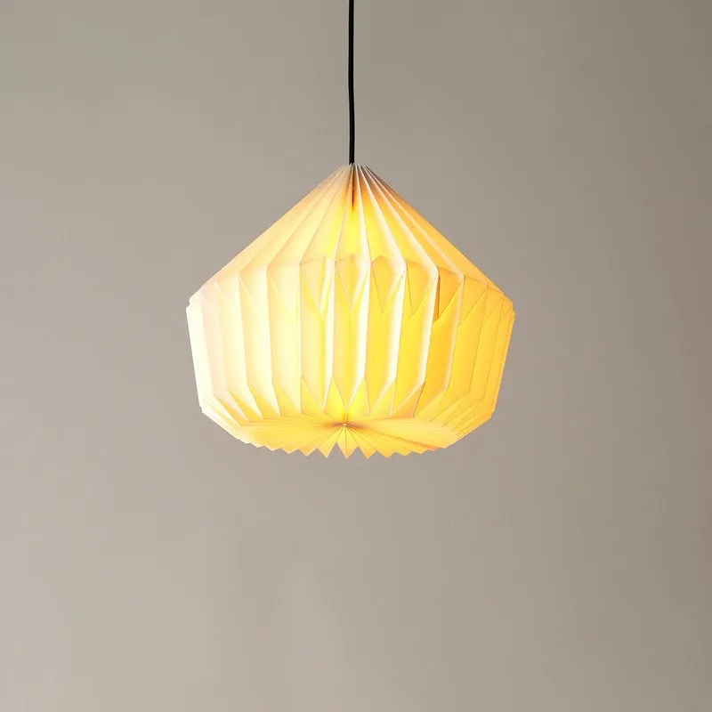 Warm-lit origami-style pendant lamp suspended from a black cord