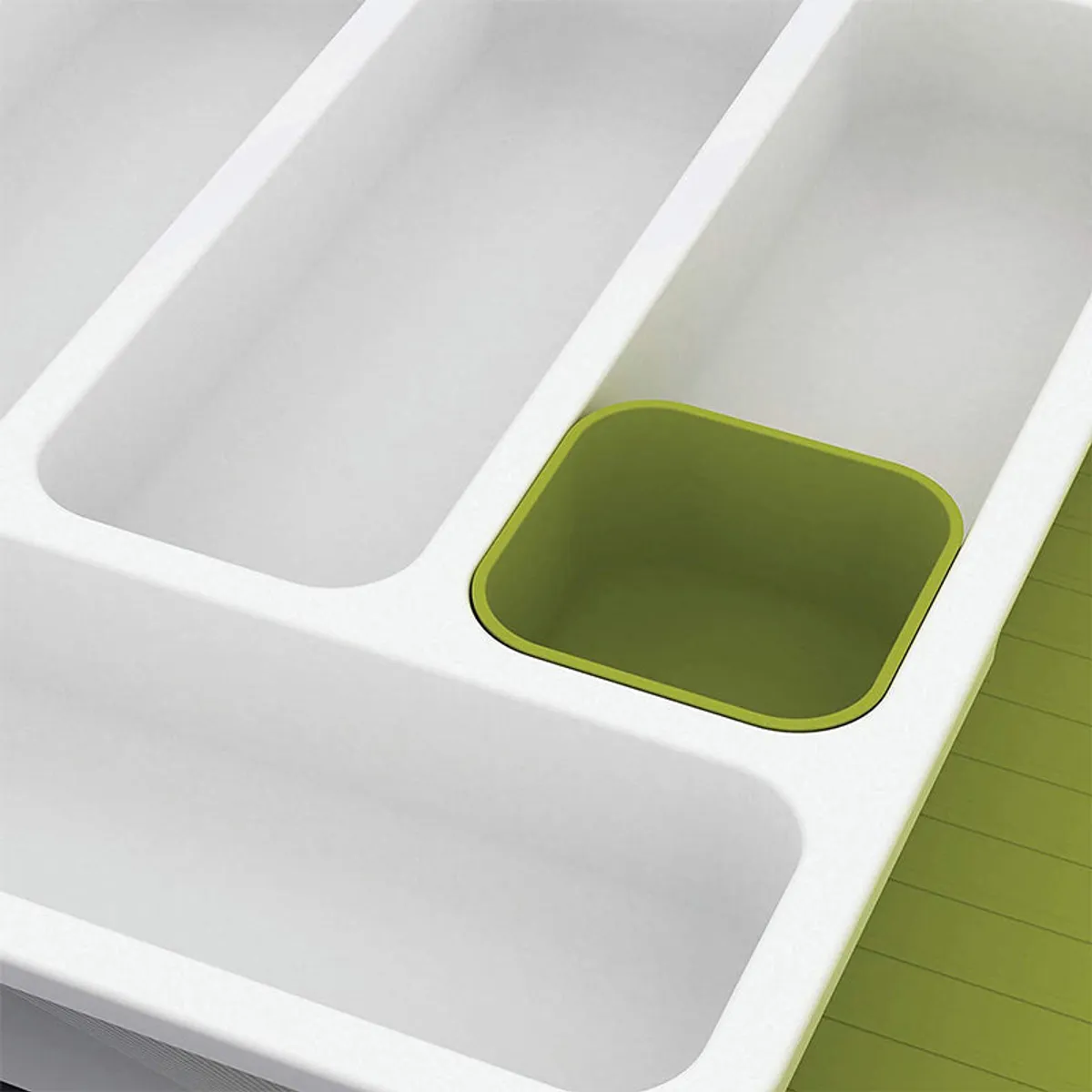 Close-up of white organiser compartments with a lime-green section