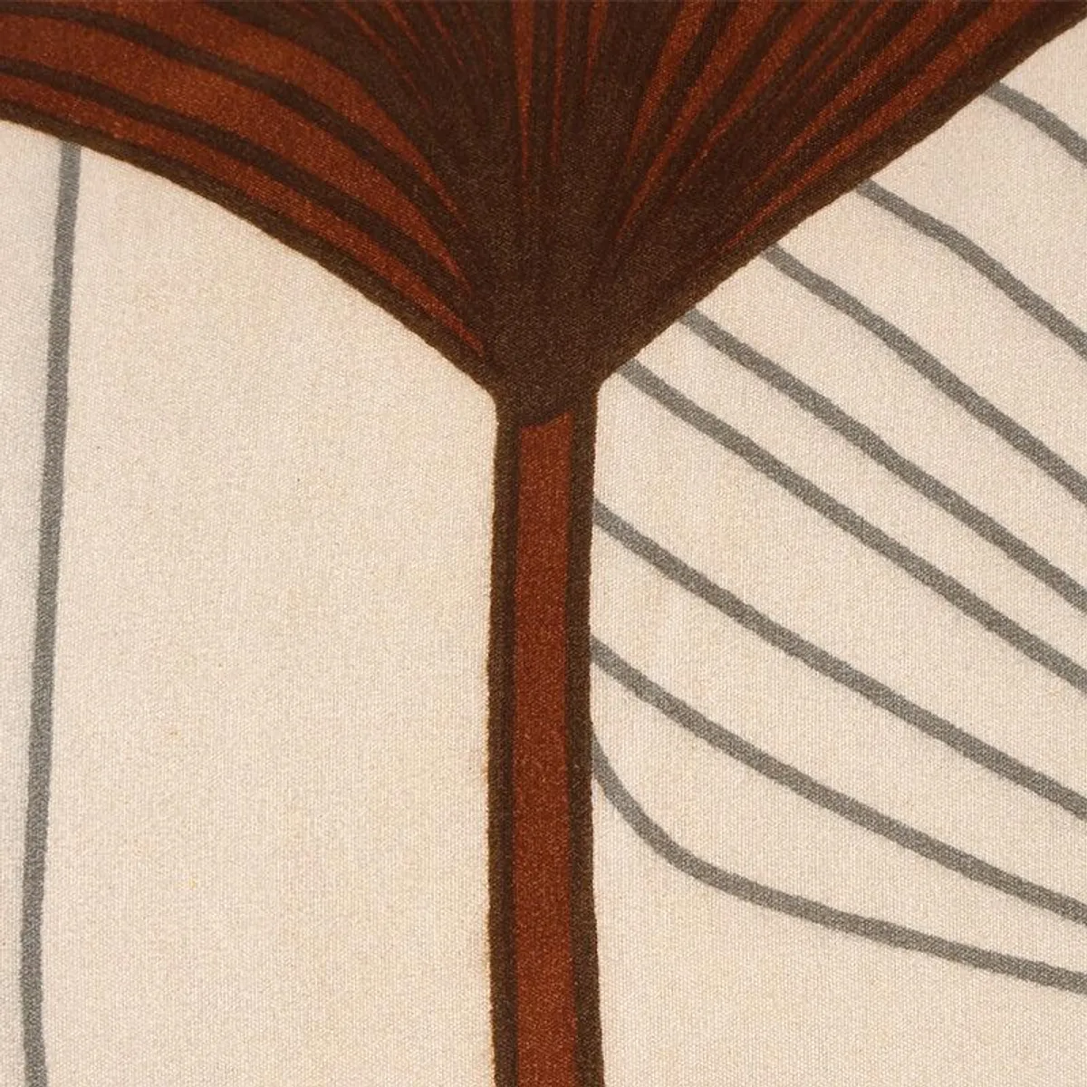 Close-up of beige fabric with brown and grey botanical print