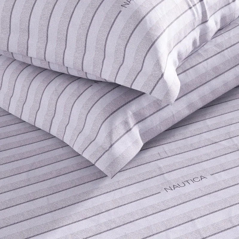 Close-up of blue striped cotton pillow covers and bedsheet