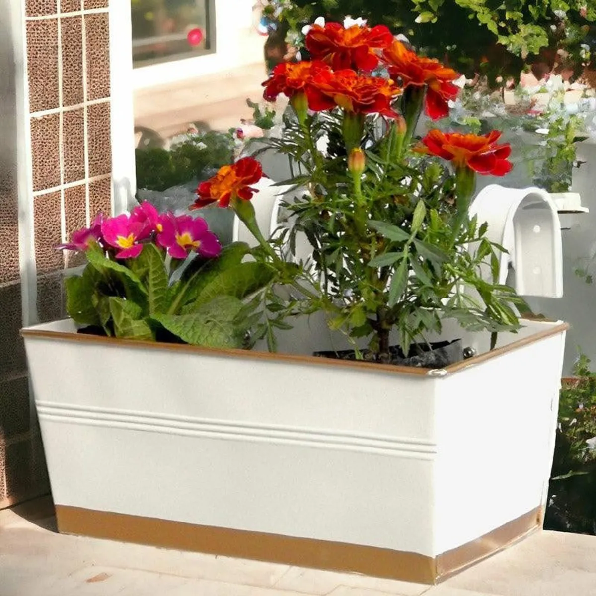 White and gold rectangular planter filled with colourful flowering plants