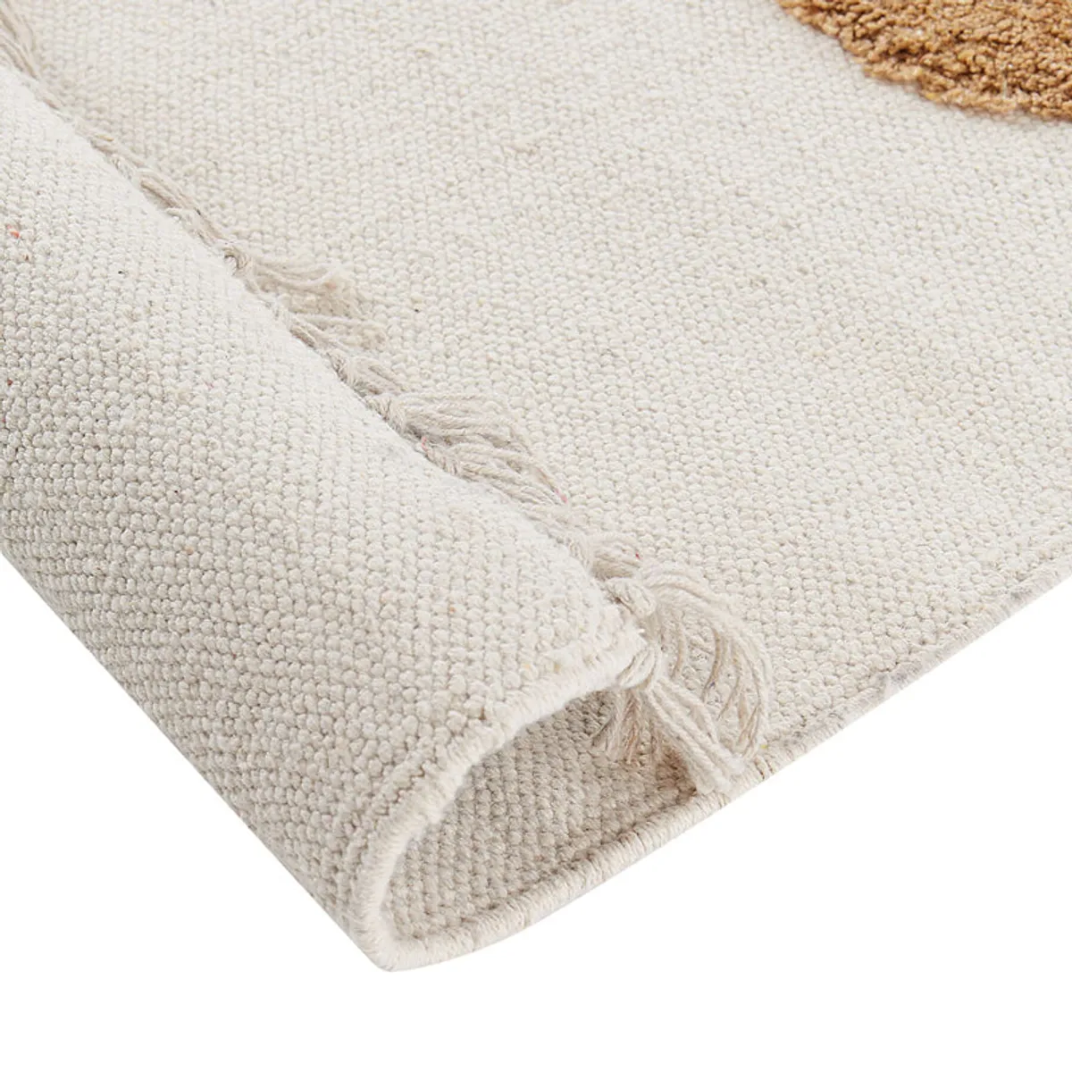 Close-up corner showing the rug's textured surface, folded edge and fringe