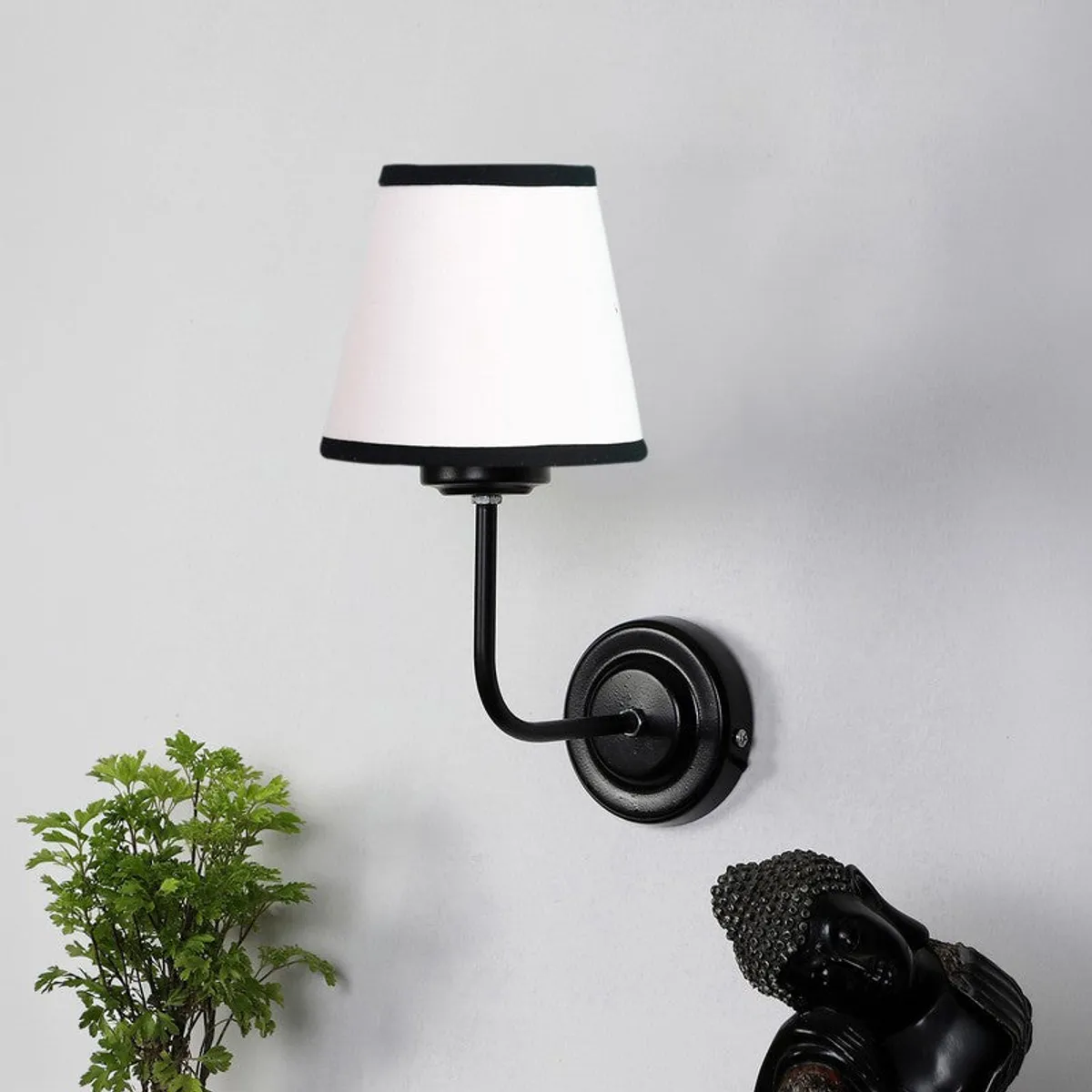 Black iron wall lamp with white tapered shade and black trim