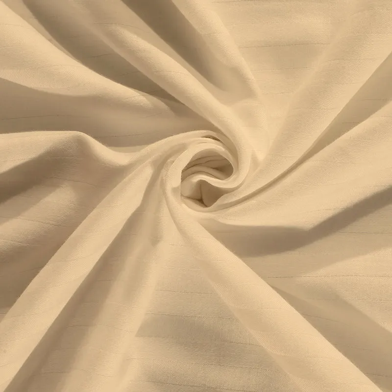 Cream bedsheet fabric in a swirl showing soft drape and fine stripes