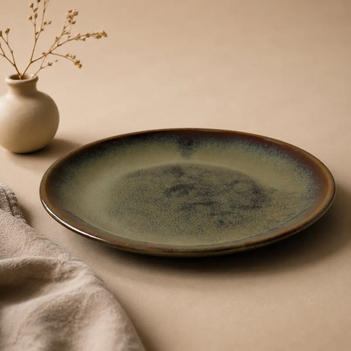 Single olive green glossy round dinner plate on a neutral surface