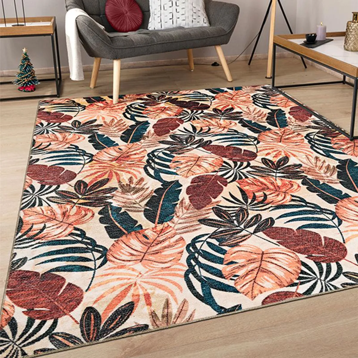 Tropical leaf print carpet in maroon and peach placed in a living room
