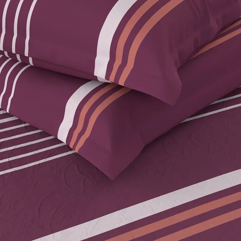 Folded maroon bedsheet and pillow cover showing stripe detail