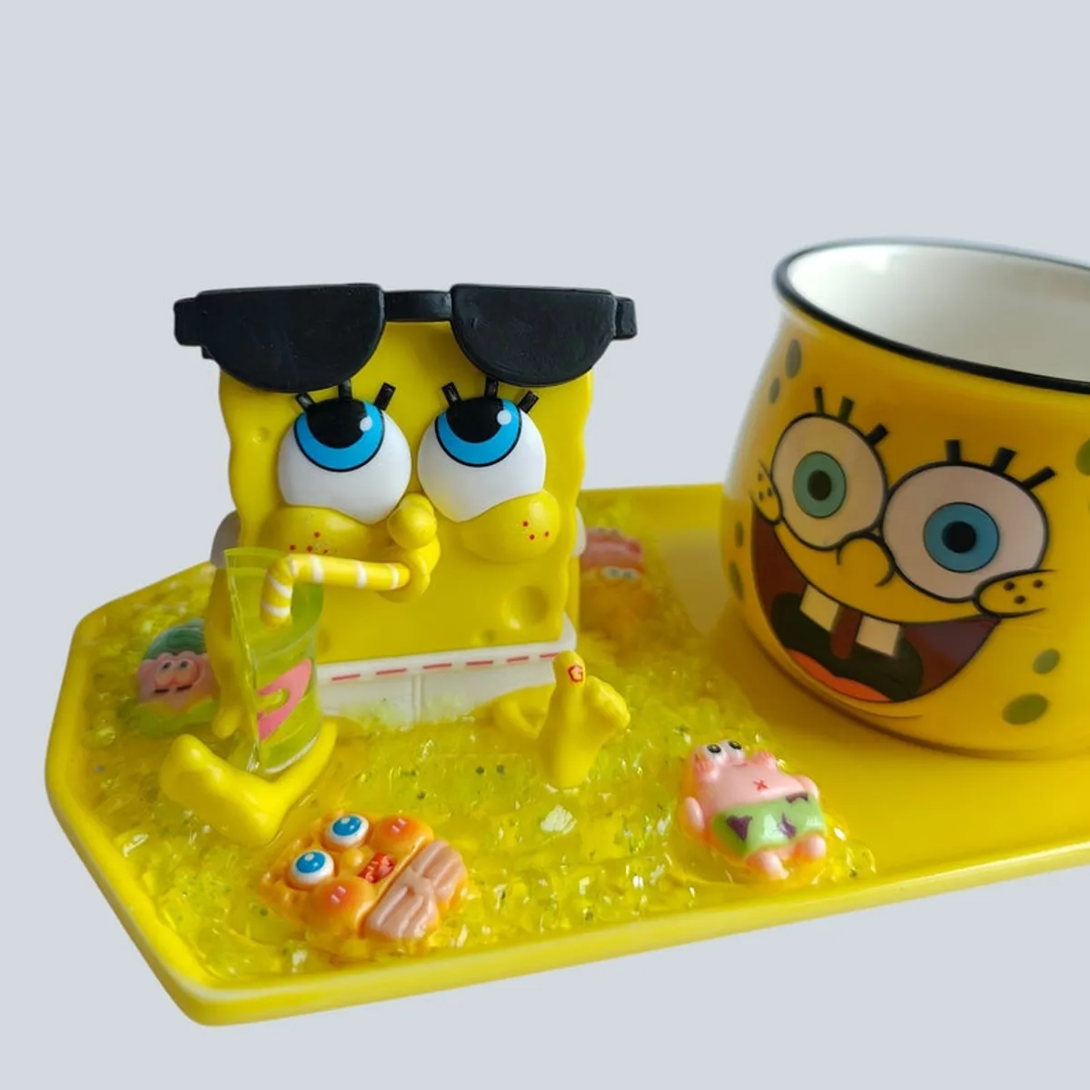 Close-up of SpongeBob figurine and illustrated yellow mug