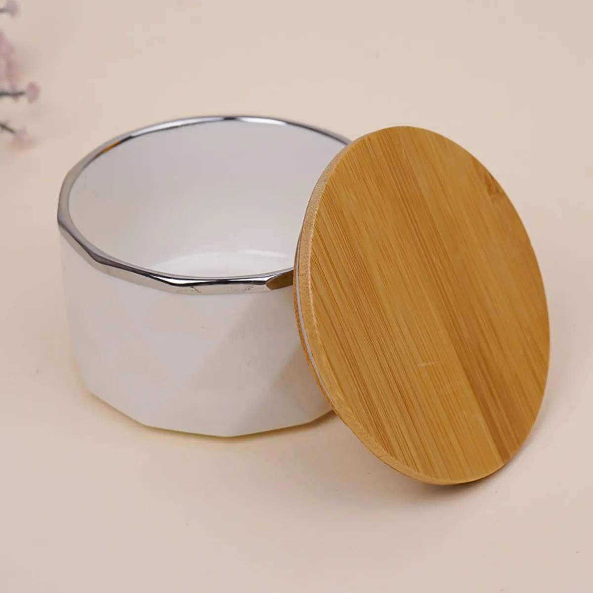 White porcelain storage jar with a round bamboo lid shown beside it