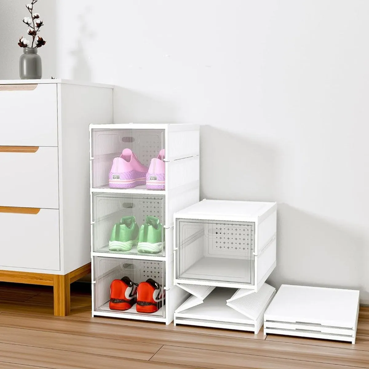 White modular shoe rack shown stacked and partially unfolded beside separate panels
