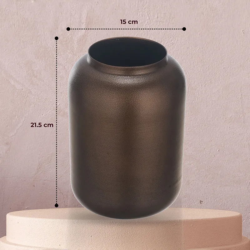 Brown metal vase shown front-facing on a pedestal