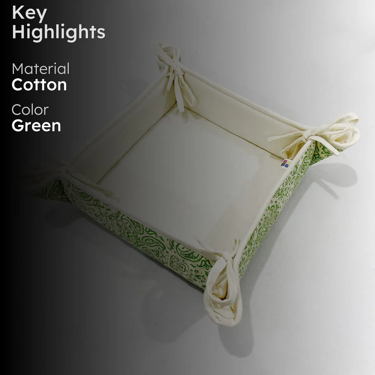 Square cream bread basket with green paisley sides and corner ties