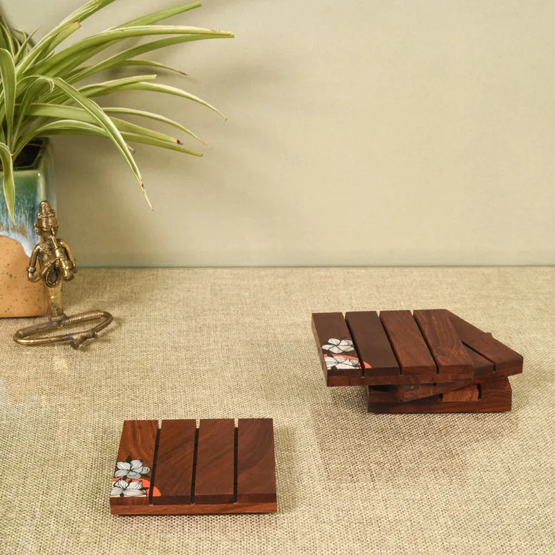 Single coaster in front with a stacked set of matching brown wooden coasters behind