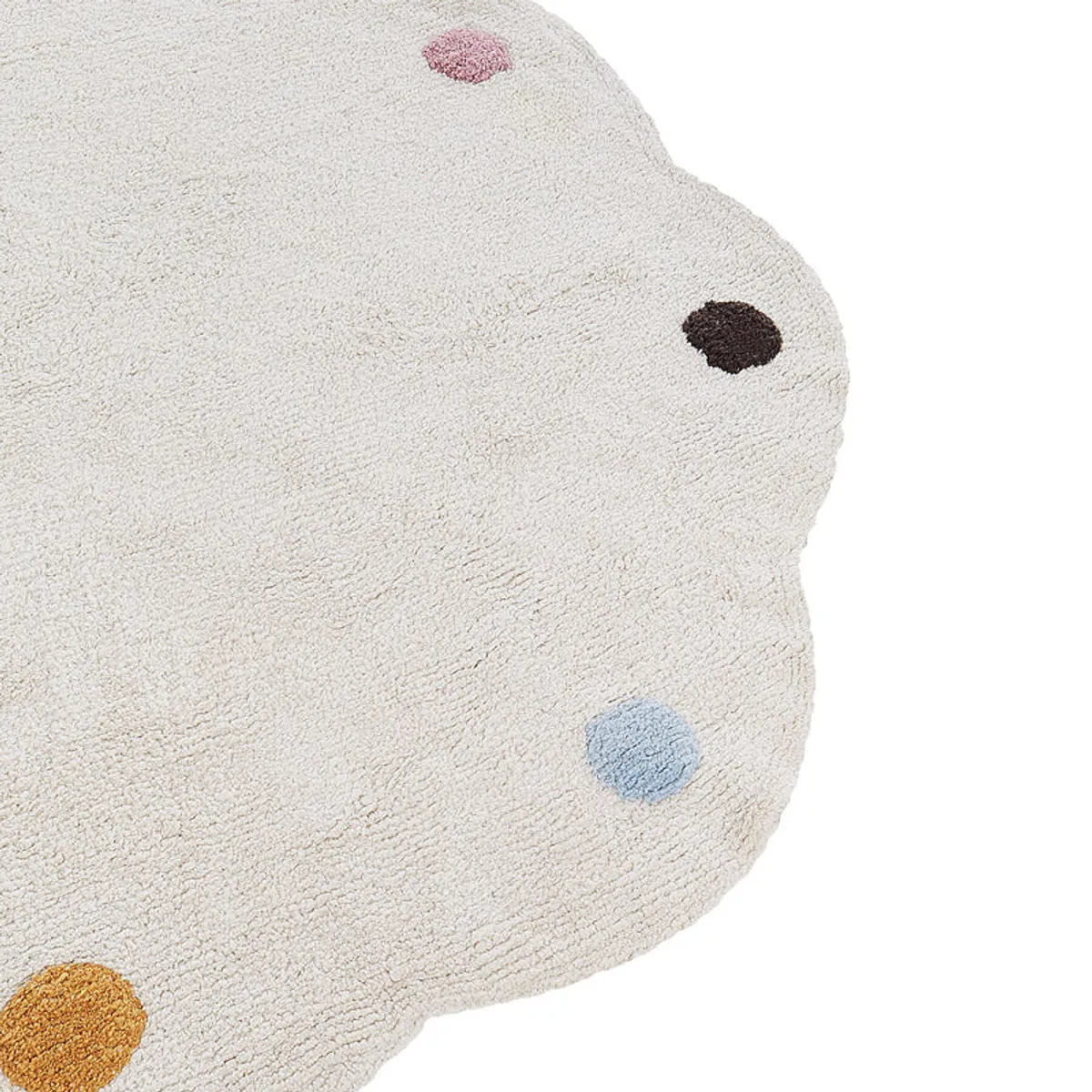 Close-up of the white textured rug with pink, brown, blue and yellow tufted dots