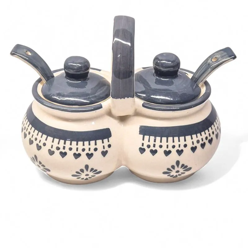 Blue and white ceramic dual condiment jar with two lidded compartments.