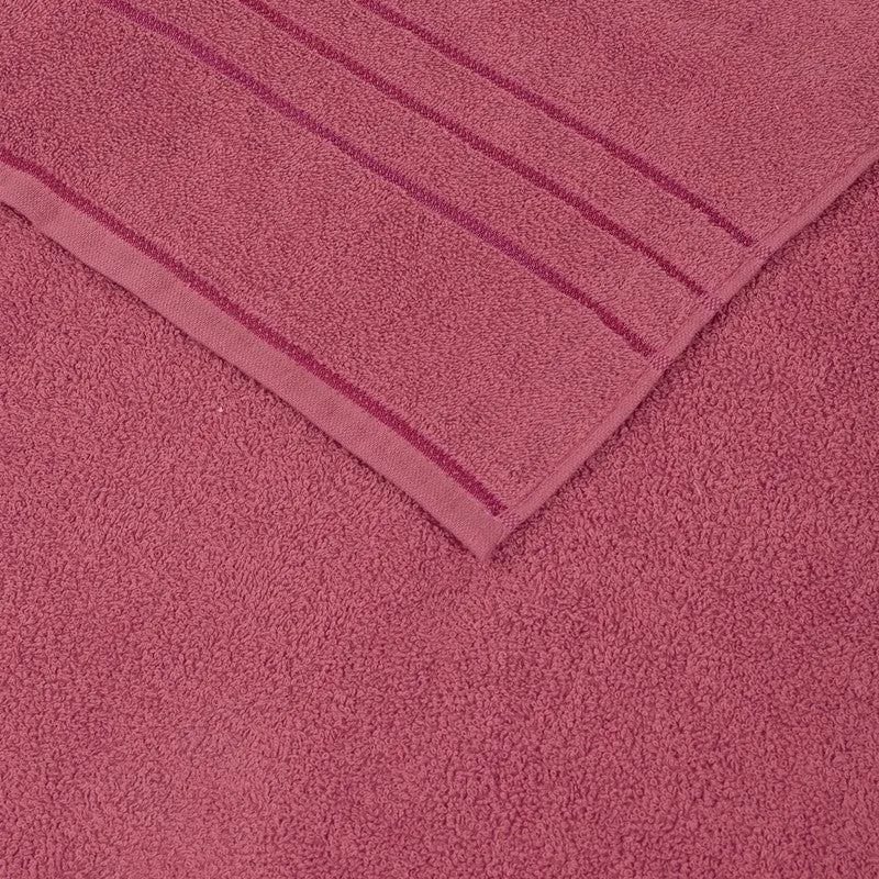 Close-up of dusty pink bath towel texture and woven border