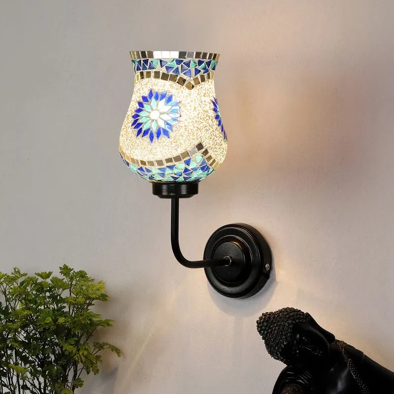 Glowing floral mosaic wall lamp mounted on wall with black round base