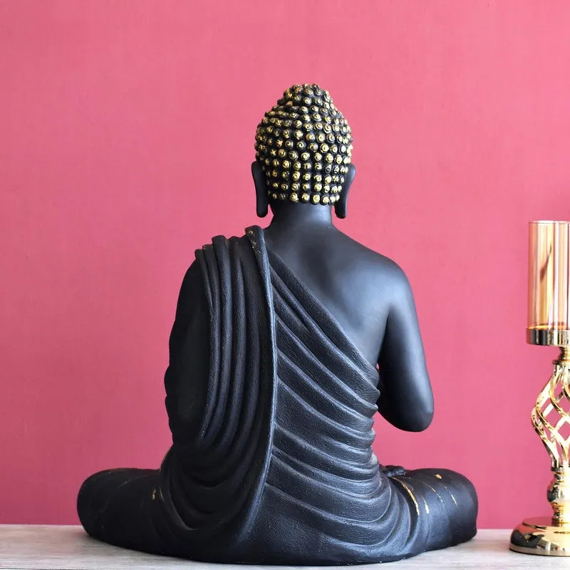 Rear view of the black meditating Buddha idol with draped robe detail