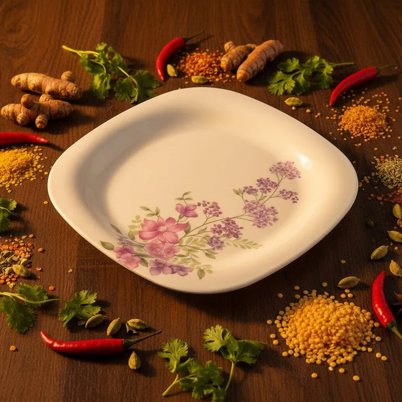 White square floral dinner plate shown with spices and herbs around it