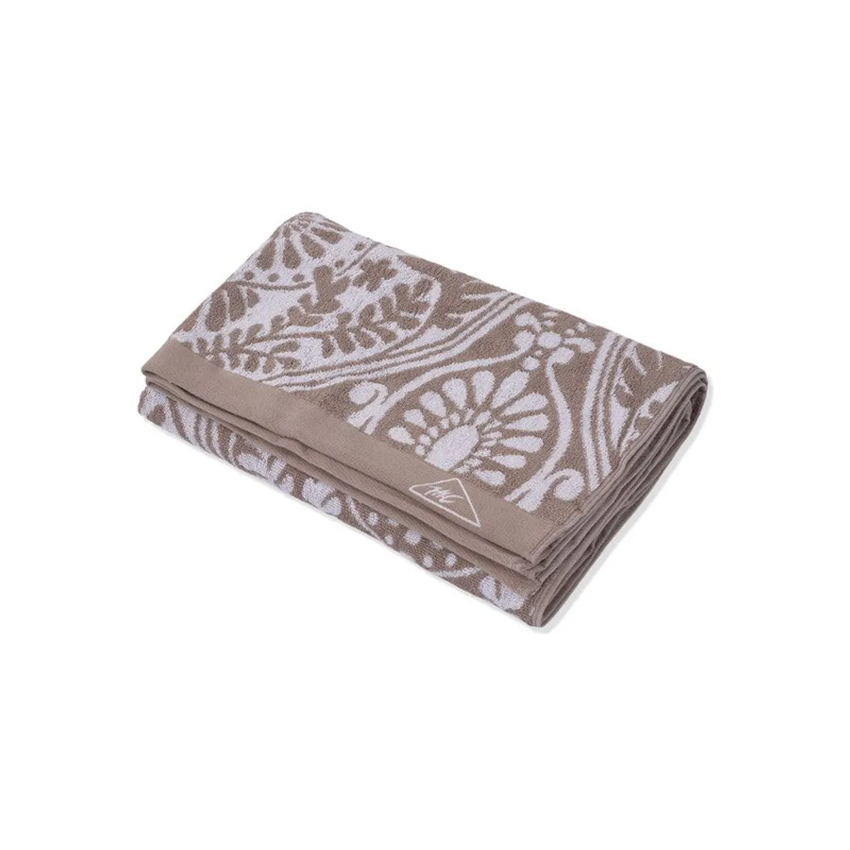 Folded beige and white patterned bath towel on a white background