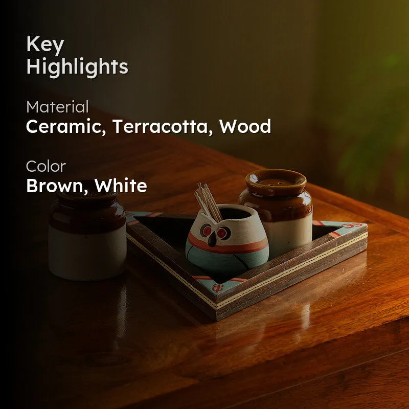 Ceramic shaker set styled on a wooden table with brown and white accents
